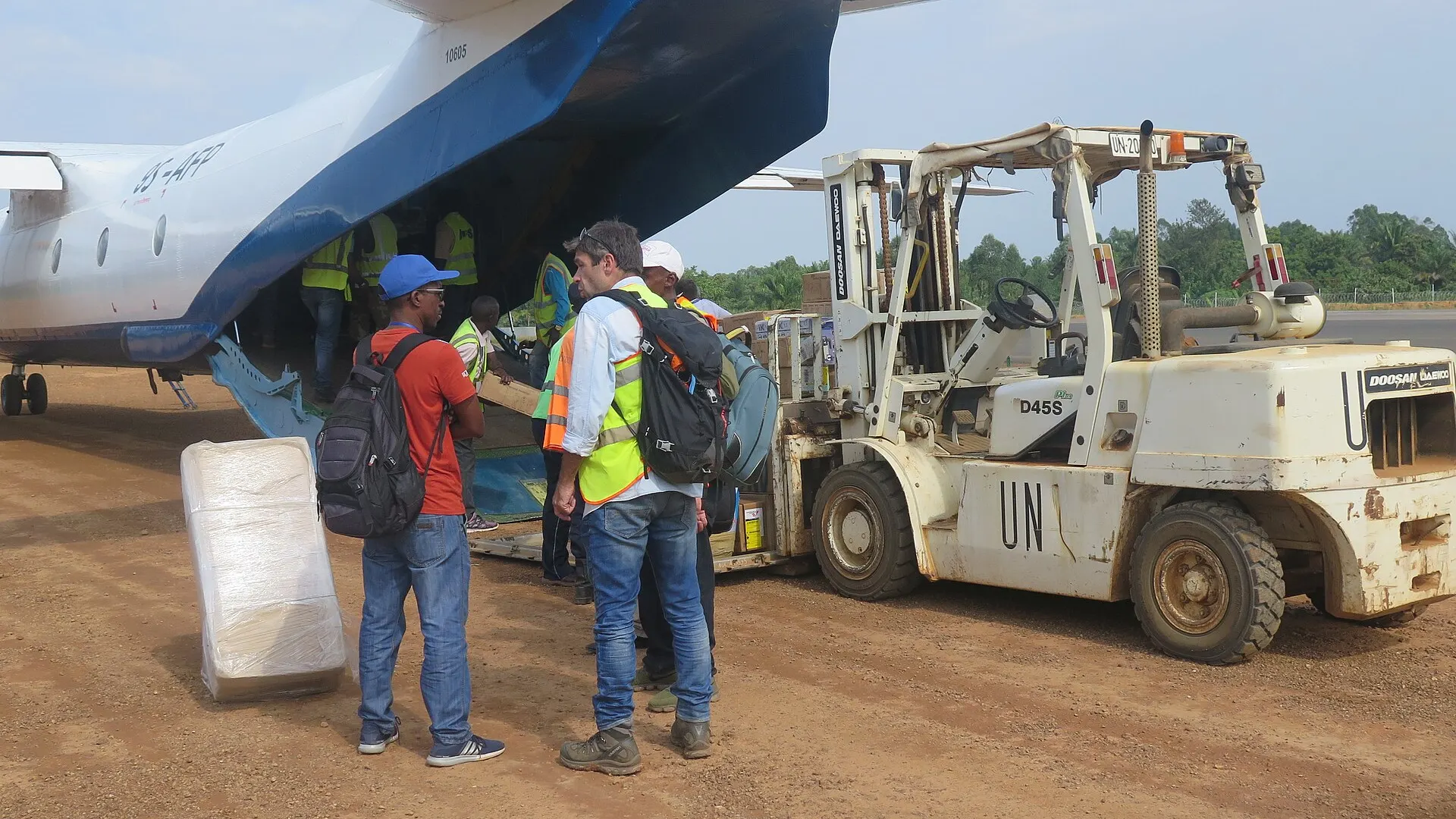 Workers unload boxes of medical supplies from an aircraft on the apron at Beni airport in North Kivu province, Democratic Republic of Congo