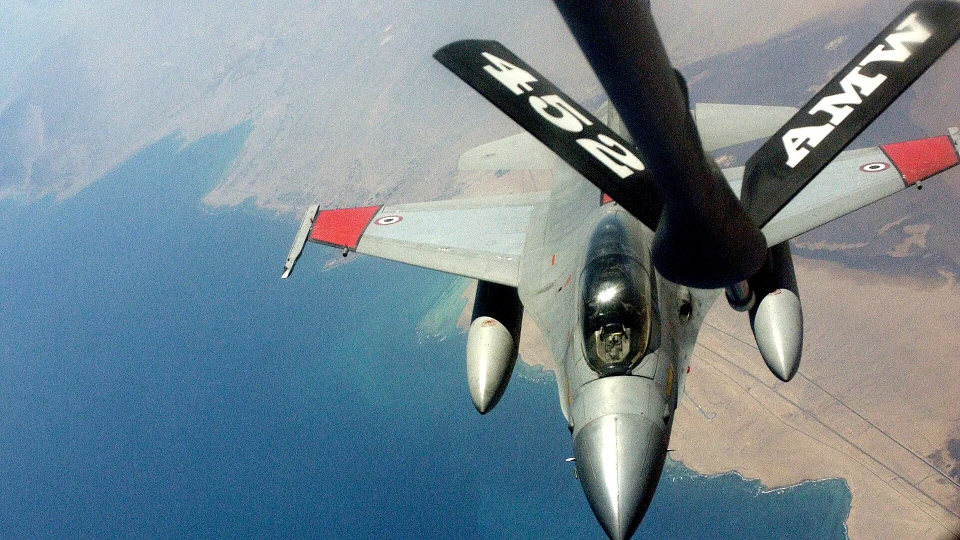 An Egyptian air force F-16 Fighting Falcon fighter jet in flight as it approaches a US KC-135 tanker for aerial refuelling