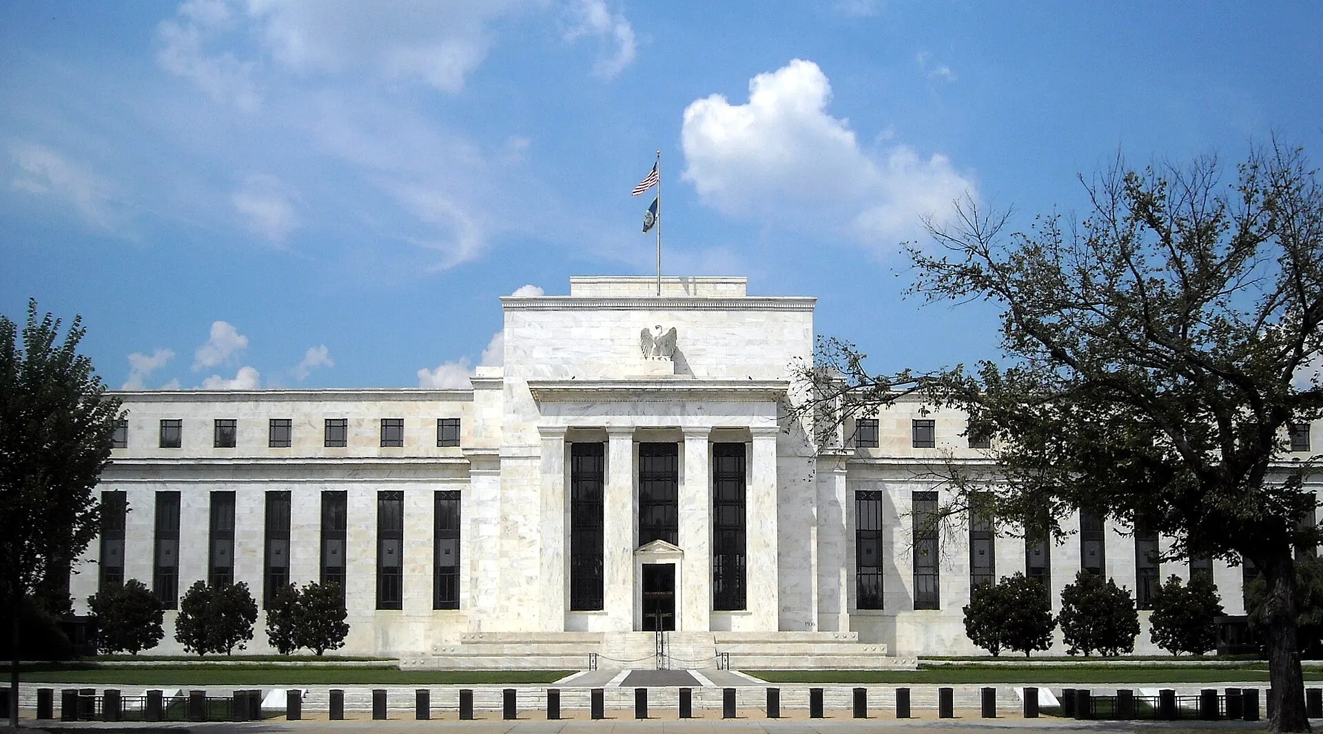 The neoclassical white marble Marriner S. Eccles Federal Reserve Board Building on Constitution Avenue in Washington, seen from the street