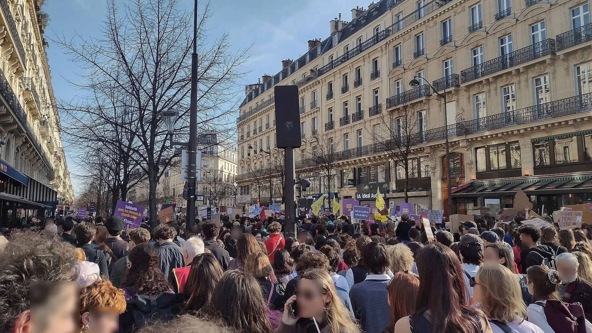 Crowds of demonstrators fill the Place de la République in Paris around the statue of Marianne during a daytime march.