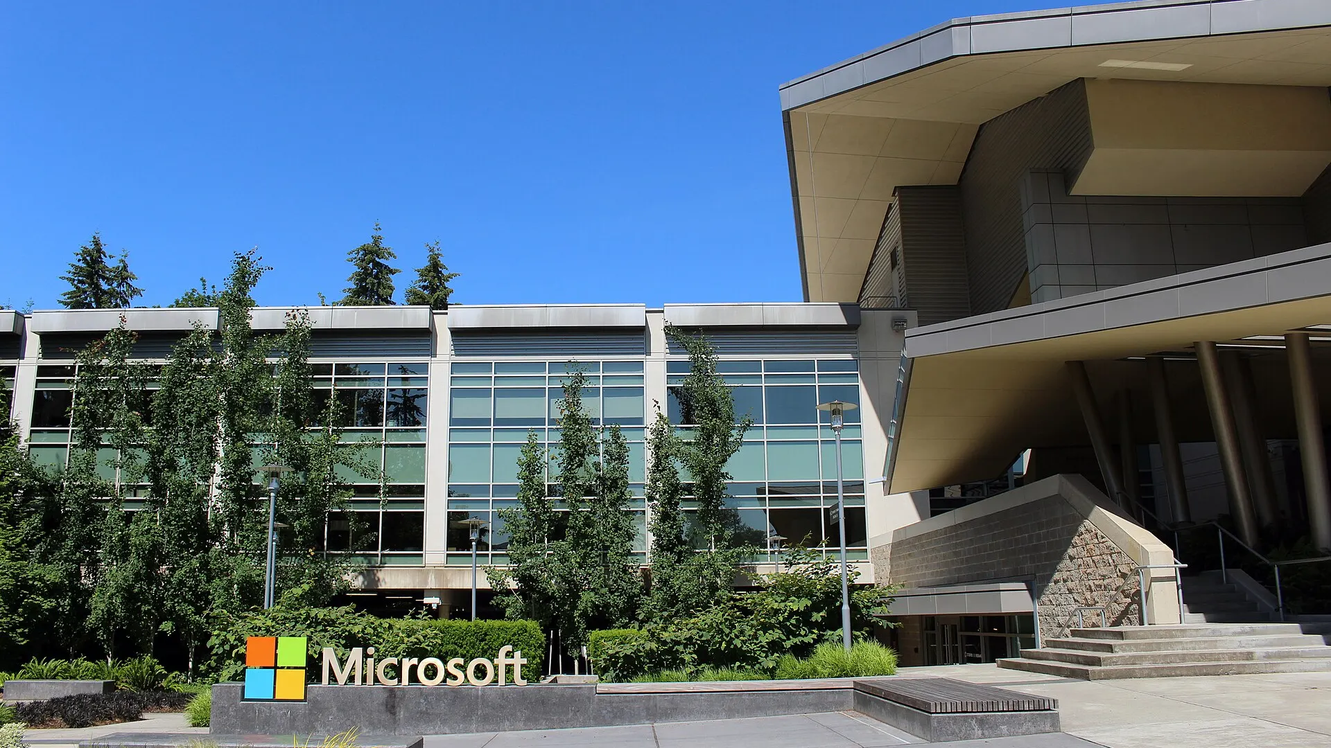 The Microsoft logo on a stone sign outside Building 92, the glass-fronted visitor centre at the company's Redmond, Washington headquarters