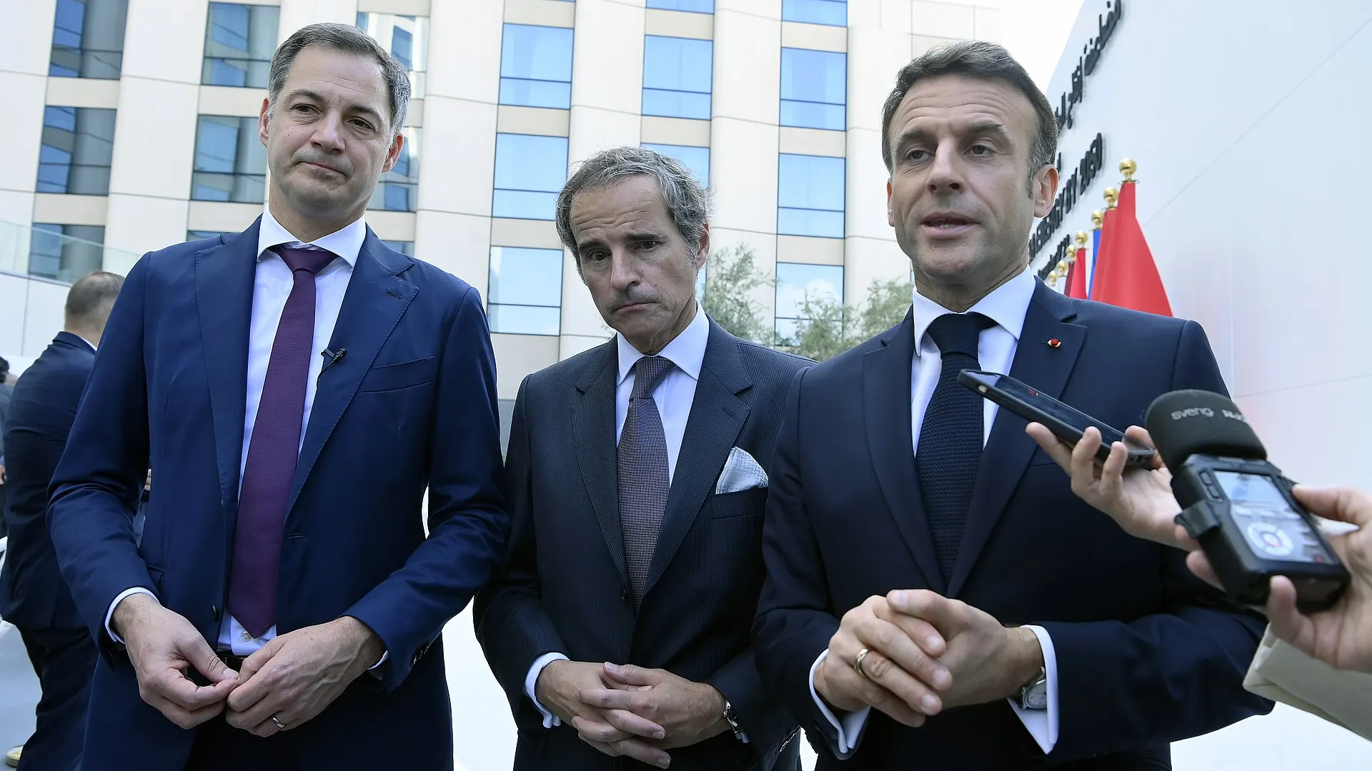 Emmanuel Macron, right, speaks to reporters beside Alexander De Croo and Rafael Grossi outside a building at Expo City Dubai in December 2023