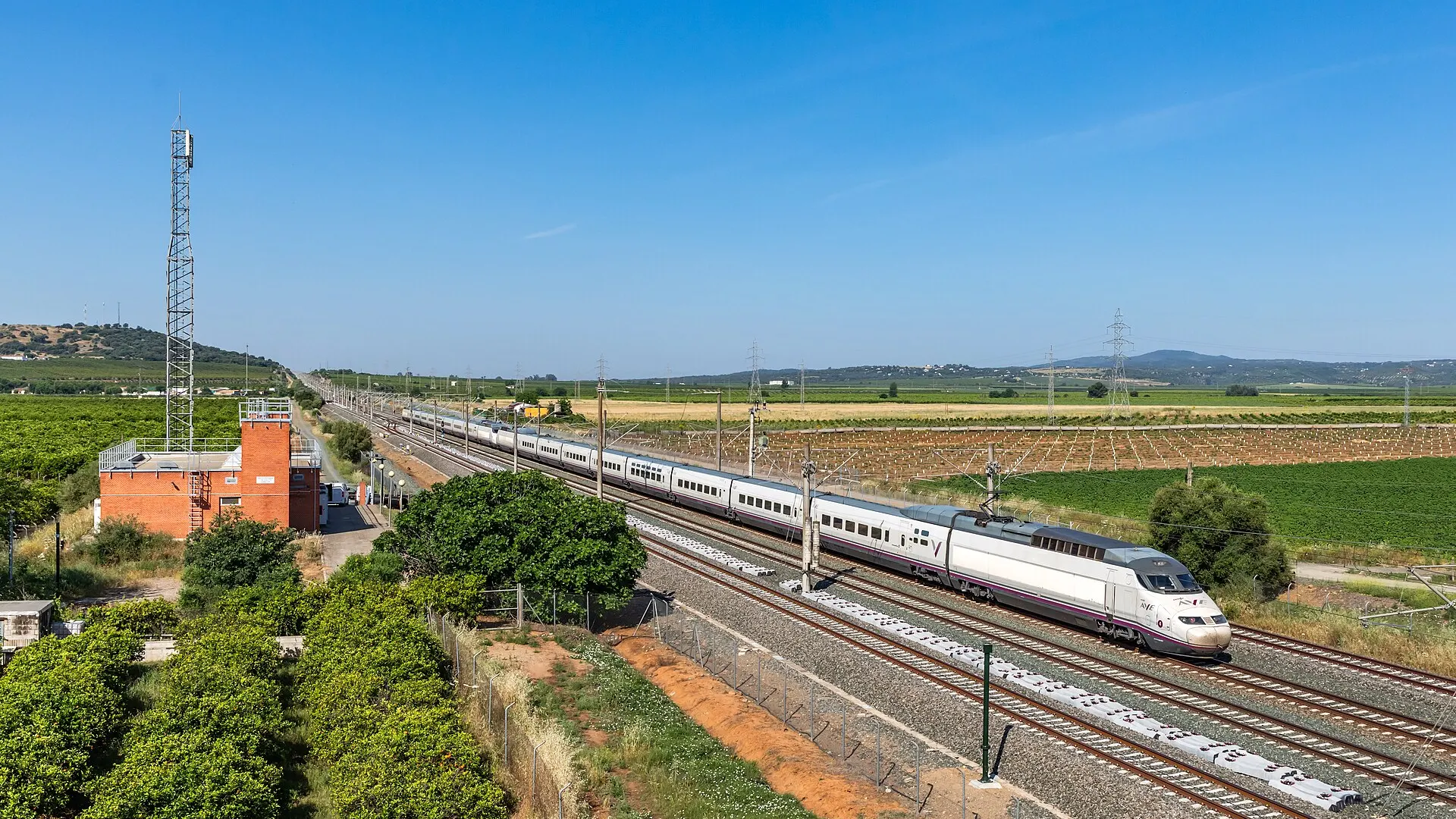 Two white and grey Renfe series 100 AVE high-speed trains standing at the ADIF maintenance depot at Hornachuelos in southern Spain